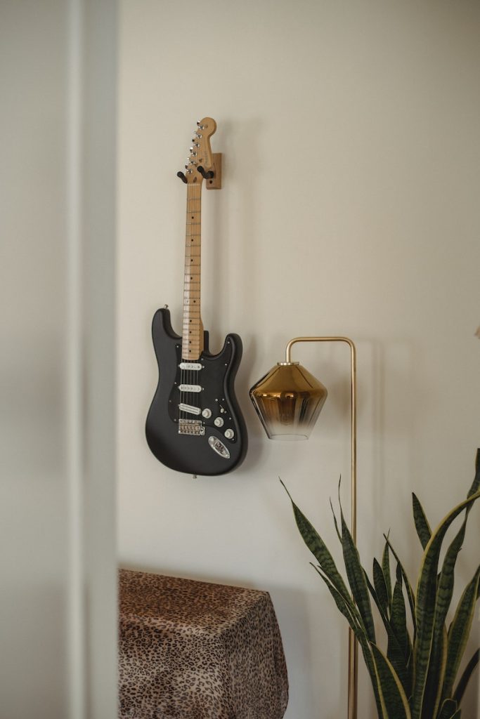 Rock guitar on wall in room at home