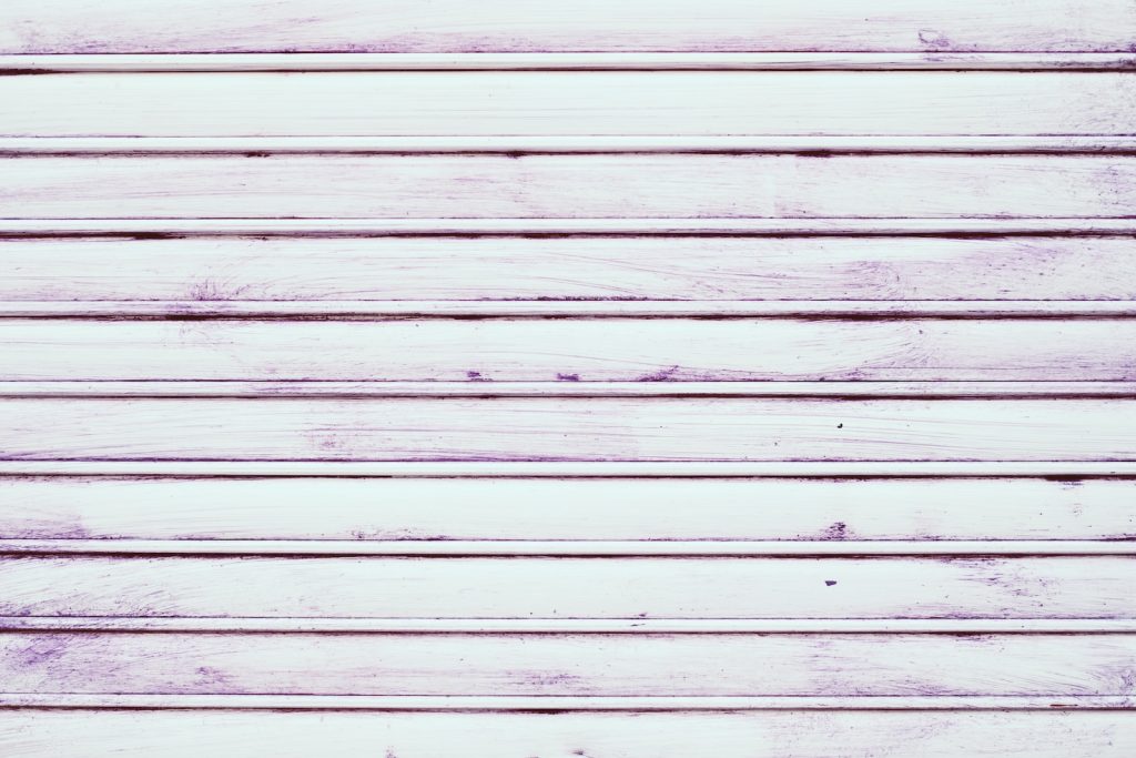 a close up of a white wooden wall