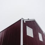 low-angle photography of red wooden house