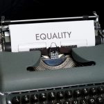 a typewriter with a paper that reads equality