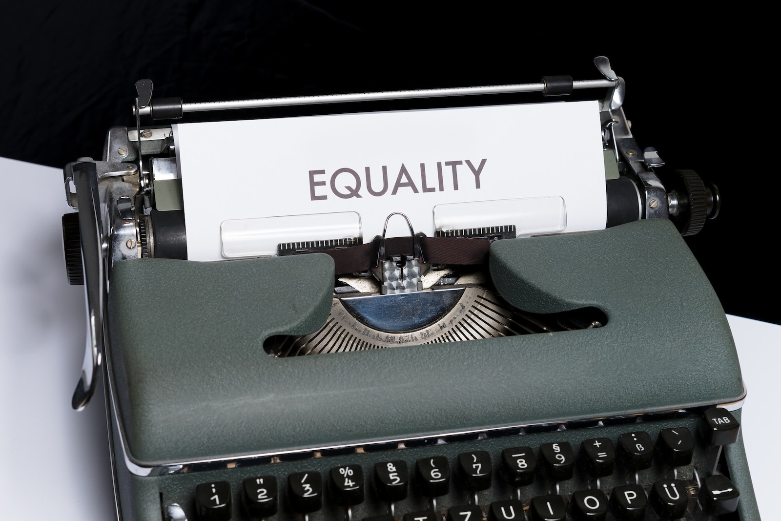 a typewriter with a paper that reads equality